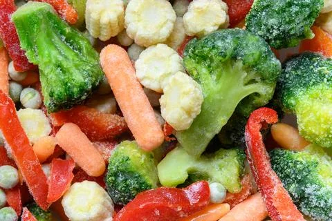 Frozen colorful vegetables. Abstract pattern. Food background. Stock Photos