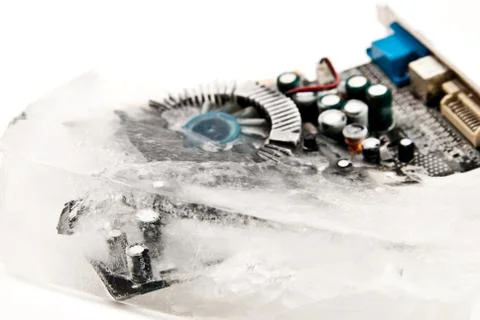 Frozen computer part in ice cube on winter time Stock Photos