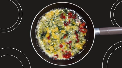 Frozen corn, pepper, peas and dill as ingredients in a delicious breakfast. F Stock Footage 125555250
