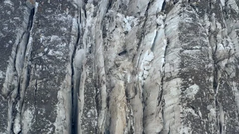 A frozen crack of glacier surface. A torn ice texture of the icefall relief and Stock Footage 169749583