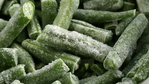 Frozen cut green beans rotating in a circle. Frozen vegetables, healthy food.  Video stock 264952038