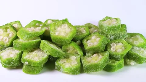 Frozen cut okra on white background, rotating Stock Footage 305962818