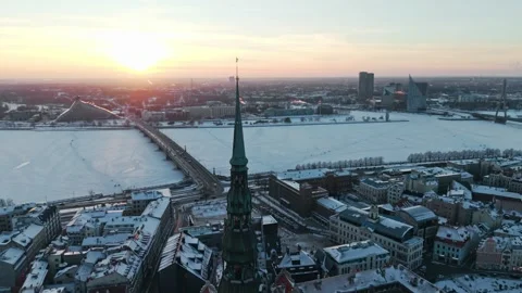 Frozen Daugava Sunset - Riga Latvia Skyline and People Walking Across River Ice Stock Footage 346307402