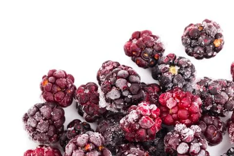 Frozen dewberries isolared on white background. Shallow depth of field Stock Photos