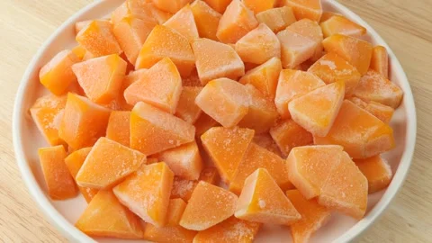 Frozen diced pumpkin pieces rotating slowly 库存影片 347685464