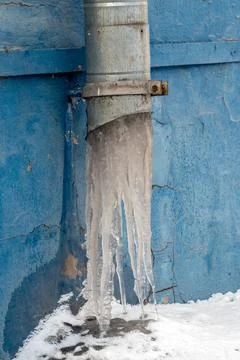 Frozen downpipe. Icicles from the downspout Stock Photos