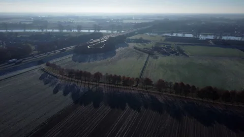 Frozen Dutch Fields: Aerial View of Majestic Landscapes with Highway and Railway Stock Footage 241107867