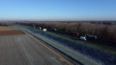 Frozen Dutch Fields: Aerial View of Majestic Landscapes with Highway and Railway Stock Footage 241113425