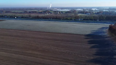 Frozen Dutch Fields: Aerial View of Majestic Landscapes with Highway and Railway Stock Footage 241113642