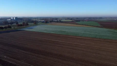 Frozen Dutch Fields: Aerial View of Majestic Landscapes with Highway and Railway Stock Footage 241115894