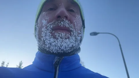 The frozen face of a man after jogging in the cold Stock Footage 260343328