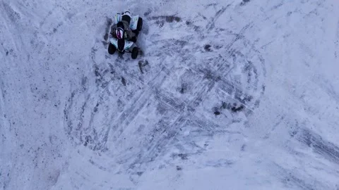 Frozen Field Showcases ATV Spinning Donuts With Circular Tire Marks Under Blue Stock Footage 327051253