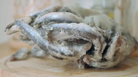 Frozen fish being prepared in a kitchen setting Stock Footage 342689550