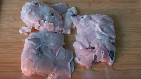 Frozen fish fillets are wrapped in ice, Sliced fish fillets thaw slowly Stock Footage 318835808