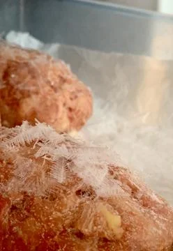 Frozen food items display a layer of frost and ice crystals, indicating their Stock-Fotos