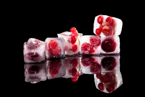 Frozen fruit in ice. Stock Photos