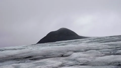 Frozen Glacier Surface with Mountain Peak Stock Footage 319700278