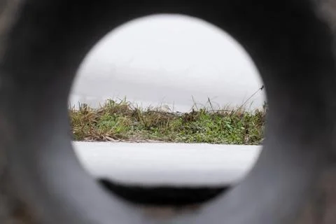 Frozen grass in landscape. View from pipe Stock Photos