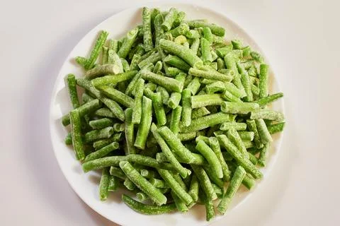 Frozen green string beans covered in frost Stock Photos