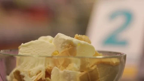 Frozen ice cream sliced in a transparent plate Stock Footage 74504067