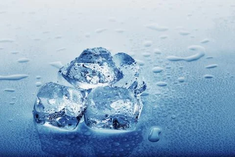 Frozen ice cubes in drops on the table Stock Photos