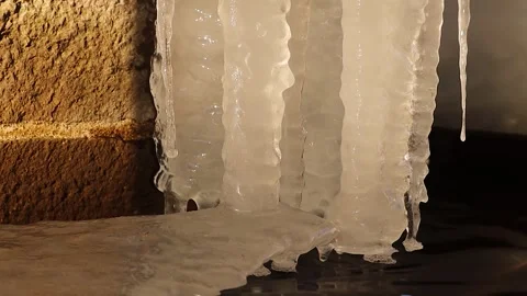 Frozen ice formations on an ancient spring wall, winter’s icy beauty Stock Footage 303651002