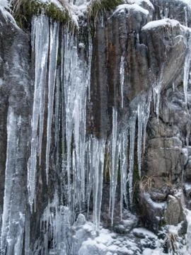 Frozen ice hanging down from the mountain side Stock Photos