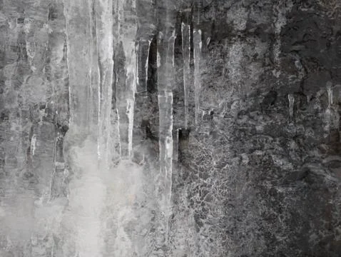 Frozen ice hanging down from the mountain side Stock Photos