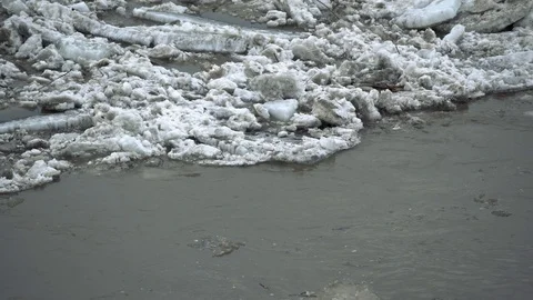 Frozen ice river is melting in spring with ice flakes flowing. Cracked ice Stock-Footage 88730447