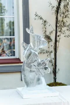 Frozen ice sculpture in the shape of a hare or rabbit decorates the festive Stock Photos