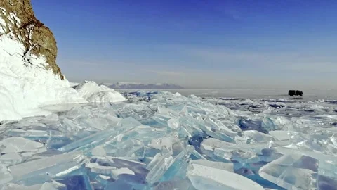 Frozen Ice Shards Under Clear Sky. Stillness Surrounds Sharp Blue Ice Pieces Stock-Footage 339205600