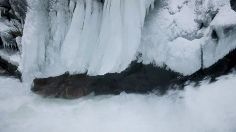 Frozen Icicles Above Raging Waterfall Stock Footage 304964384