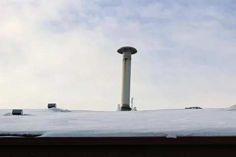 Frozen icicles beside a chimney stack in winter Stock Photos