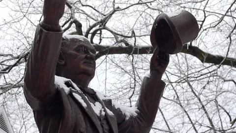 Frozen icicles form on a snow covered Statue of P.T. Barnum during the winter Stock Footage 120797909