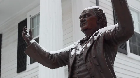 Frozen icicles form on a snow covered Statue of P.T. Barnum during the winter Stock Footage 120798222