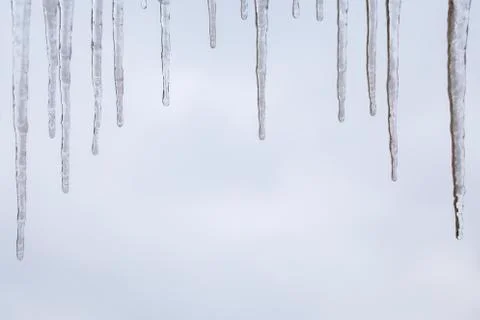Frozen icicles hanging with sky background and copy space 2 Stock Photos