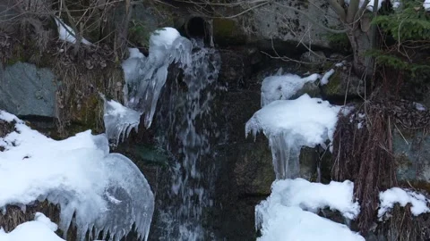 Frozen icy waterfall flowing in winter Stock Footage 328007195