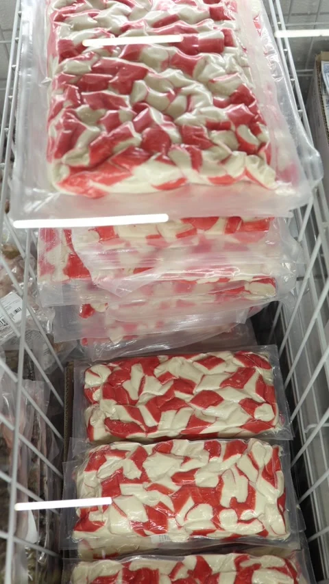 Frozen imitation crab sticks packed in clear bags inside a store freezer Stock Footage 345978509