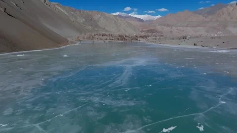 Frozen Indus River with Basgo Village and Snow-Capped Mountains in Ladakh, India Stock Footage 333823488
