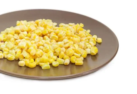 Frozen kernels of sweet corn on the brown dish closeup Stock Photos
