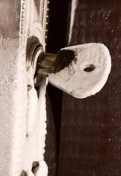 Frozen key in the door lock Stock Photos