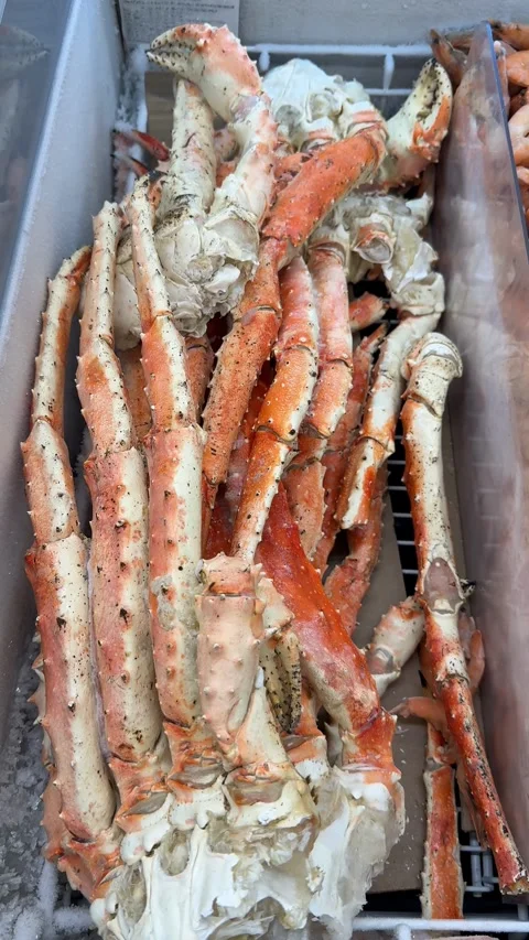 Frozen king crab legs displayed in freezer at seafood market Stock Footage 316611375