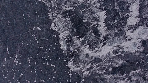 Frozen lake Baikal covered with snow and ice. Cars are driving over the ice Stock Footage 78488357