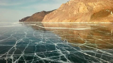 Frozen lake in the cracks against the backdrop of rocks Stock Footage 144222452
