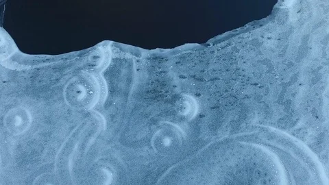 Frozen lake fly over with patterns in the ice Stock Footage 87437555