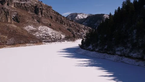 Frozen Lake in Mountain Pine Trees and Rocks Stock Footage 87889816