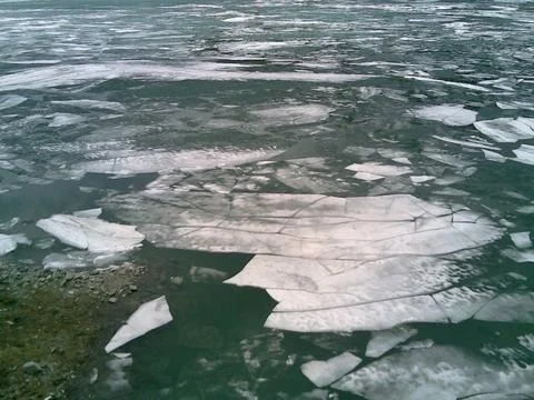 Frozen lake in the process of thawing Stock Photos