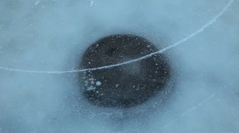 Frozen lake with skater going fast over a frozen hole Video stock 45112372