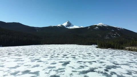 Frozen Lake with snow and distant peak, straight drone shot Stock Footage 289576545