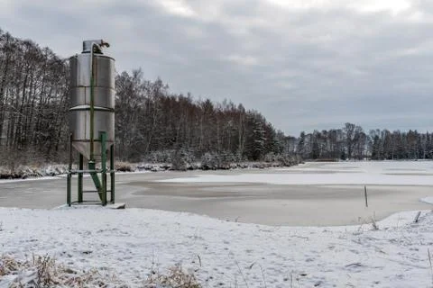 A frozen lake at Studnice with a silo in front Stock Photos